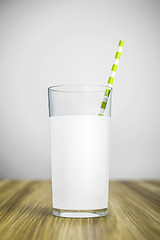 Image showing a glass of milk with a green straw