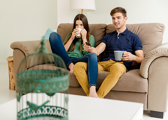 Image showing Watching tv and drinking coffee