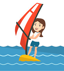 Image showing Young woman windsurfing in the sea.