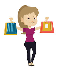 Image showing Happy woman holding shopping bags.