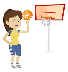 Image showing Young basketball player spinning ball.