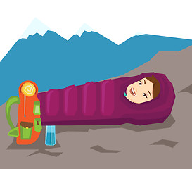 Image showing Woman resting in sleeping bag in the mountains.