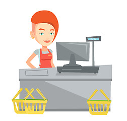 Image showing Cashier standing at the checkout in supermarket.