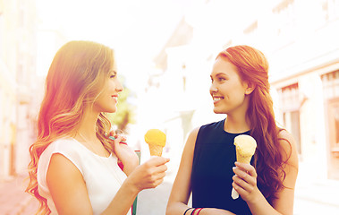 Image showing woman with shopping bags and ice cream in city