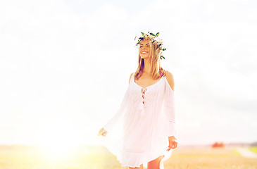 Image showing happy young woman in flower wreath on cereal field