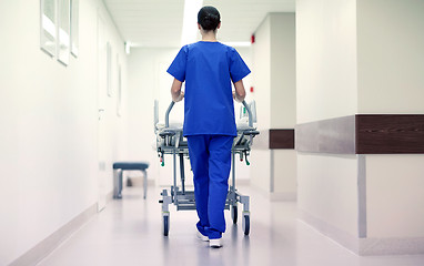 Image showing nurse carrying hospital gurney to emergency room