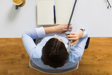 Image showing businesswoman calling on phone at office table