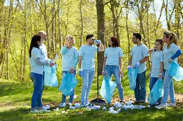 Image showing group of volunteers with garbage bags in park