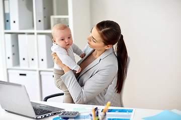 Image showing happy businesswoman with baby and laptop at office