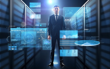 Image showing businessman with charts on virtual screen