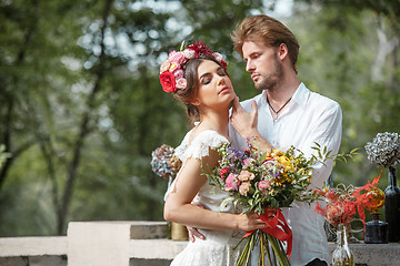 Image showing Wedding decoration in the style of boho, floral arrangement, decorated table in the garden.