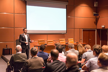 Image showing Business speaker giving a talk at business conference event.