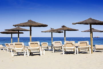 Image showing Chairs and umbrellas on a beautiful sandy beach at Ibiza