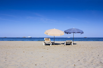 Image showing Chairs and umbrellas on a beautiful sandy beach at Ibiza