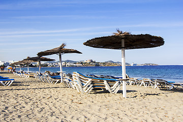 Image showing Chairs and umbrellas on a beautiful sandy beach at Ibiza