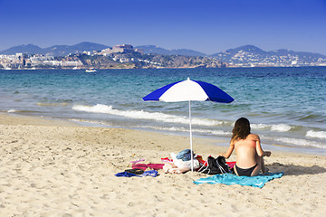 Image showing Ibiza sandy beach young girl under a umbrella