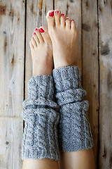 Image showing Woman's legs in knitted legwarmers.