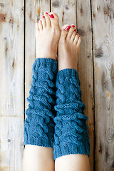 Image showing Woman's legs in knitted legwarmers.
