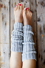 Image showing Woman's legs in knitted legwarmers.