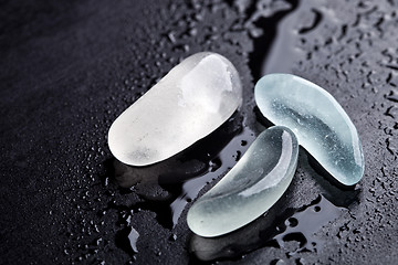 Image showing three wet pieces of glass polished by the sea