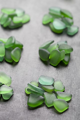 Image showing green pieces of glass polished by the sea