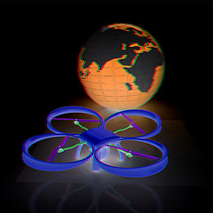 Image showing Quadrocopter Drone with Earth Globe and remote controller on a w