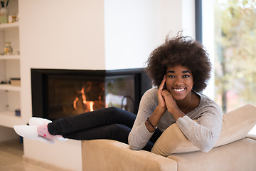 Image showing black woman in front of fireplace