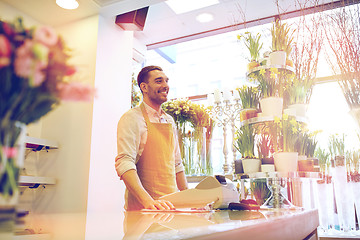 Image showing florist man or seller at flower shop counter