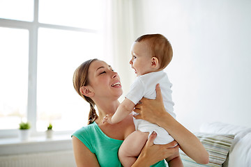 Image showing happy young mother with little baby at home