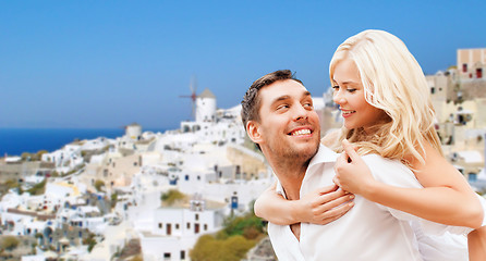 Image showing happy couple hugging over santorini island