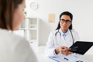 Image showing doctor with tablet pc and woman patient at clinic