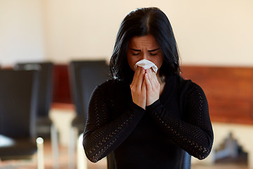 Image showing crying woman with wipe at funeral in church