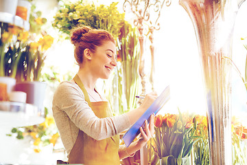 Image showing florist woman with clipboard at flower shop