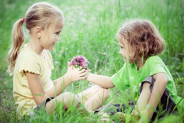 Image showing Two happy children  playing near the tree at the day time.