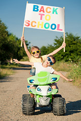 Image showing Happy little children playing on road at the day time. They driv