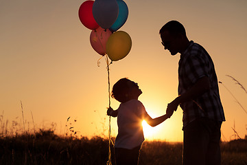 Image showing Father and son playing at the park at the sunset time.