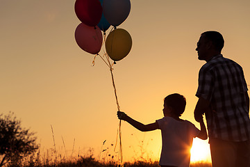 Image showing Father and son playing at the park at the sunset time.