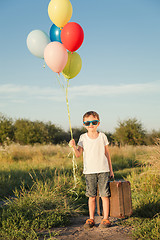 Image showing Happy little boy playing on road at the day time.