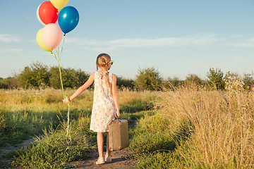 Image showing Happy little girl playing on road at the day time.