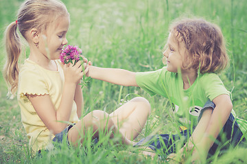 Image showing Two happy children  playing near the tree at the day time.