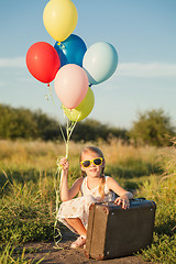 Image showing Happy little girl playing on road at the day time.