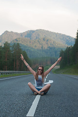 Image showing Woman sitting on the road