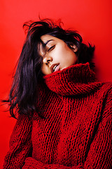 Image showing young pretty indian mulatto girl in red sweater posing emotional, fashion hipster teenage, lifestyle people concept 
