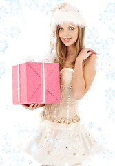 Image showing santa helper in corset and skirt with pink gift box