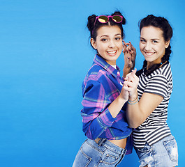 Image showing best friends teenage school girls together having fun, posing emotional on blue background, besties happy smiling, lifestyle people concept 