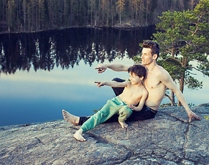 Image showing middle age man with little cute son doing sport yoga on the top of the mountain together, happy family lifestyle people outdoor, summer wild nature for training 