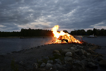 Image showing traditional bonfire on the summer solstice on the shore of the l