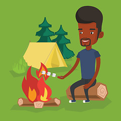 Image showing Man roasting marshmallow over campfire.