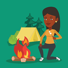 Image showing Woman roasting marshmallow over campfire.