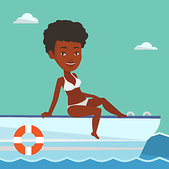 Image showing Young happy woman tanning on sailboat.